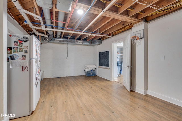 1121 Watauga St, Kingsport, TN 37660 - unfinished below grade area featuring freestanding refrigerator and light wood-style flooring