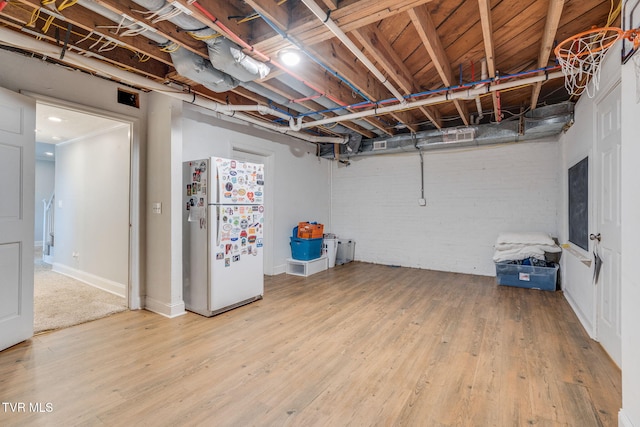 1121 Watauga St, Kingsport, TN 37660 - unfinished basement with freestanding refrigerator and wood finished floors
