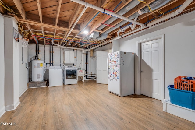 1121 Watauga St, Kingsport, TN 37660 - unfinished below grade area featuring freestanding refrigerator, separate washer and dryer, electric water heater, and light wood-style flooring