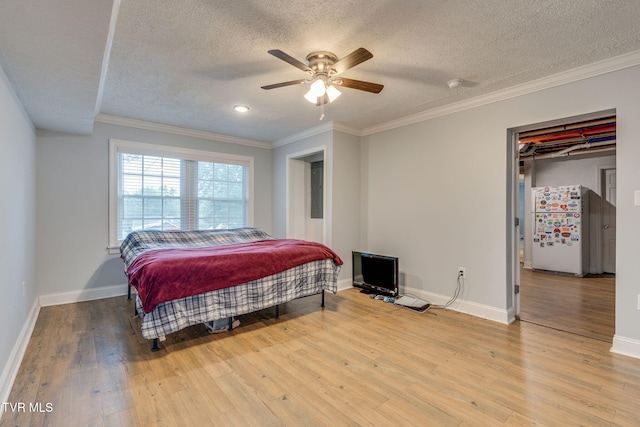 1121 Watauga St, Kingsport, TN 37660 - bedroom with freestanding refrigerator, a textured ceiling, wood finished floors, crown molding, and a ceiling fan
