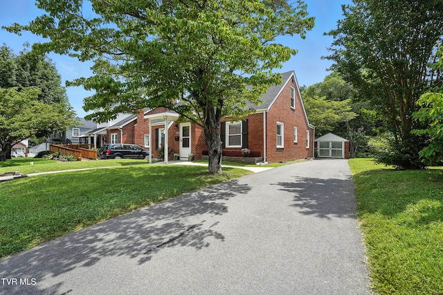 1340 Wateree St, Kingsport, TN 37660 - view of front of home featuring brick siding, driveway, a front yard, an outbuilding, and a garage