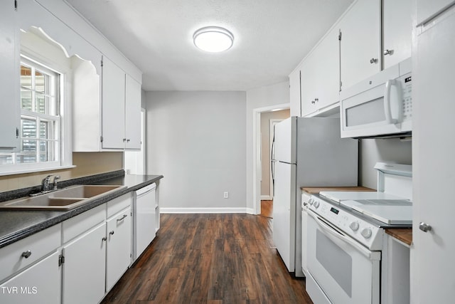 1340 Wateree St, Kingsport, TN 37660 - kitchen featuring white appliances, dark wood-style flooring, dark countertops, and white cabinets