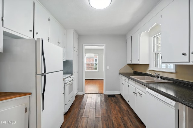 1340 Wateree St, Kingsport, TN 37660 - kitchen with white appliances, dark countertops, white cabinetry, and dark wood-style floors