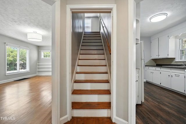 1340 Wateree St, Kingsport, TN 37660 - stairway with a textured ceiling and wood finished floors