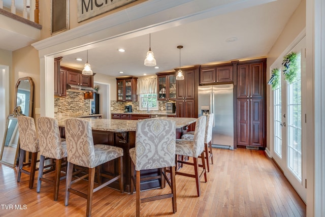 2424 Rivermont Dr, Kingsport, TN 37660 - kitchen with stainless steel fridge, under cabinet range hood, tasteful backsplash, healthy amount of natural light, and recessed lighting