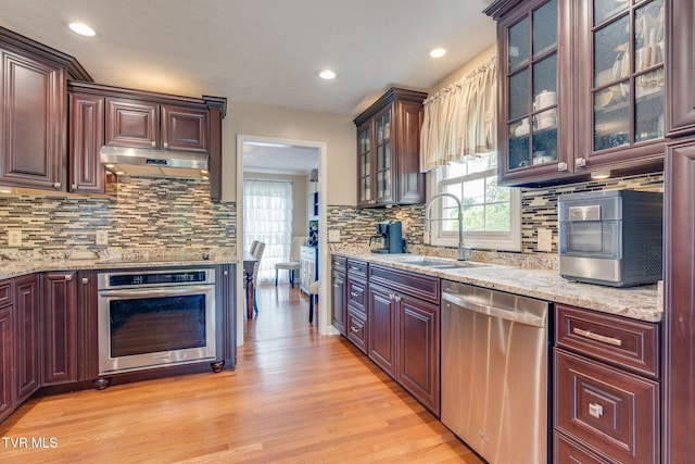 2424 Rivermont Dr, Kingsport, TN 37660 - kitchen with appliances with stainless steel finishes, under cabinet range hood, healthy amount of natural light, light wood-style flooring, and recessed lighting