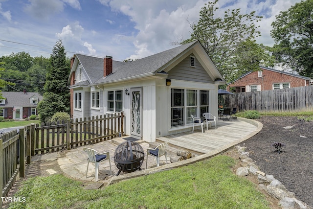 3277 Ashley St, Kingsport, TN 37664 - back of house with a fire pit, a wooden deck, a shingled roof, and a fenced backyard