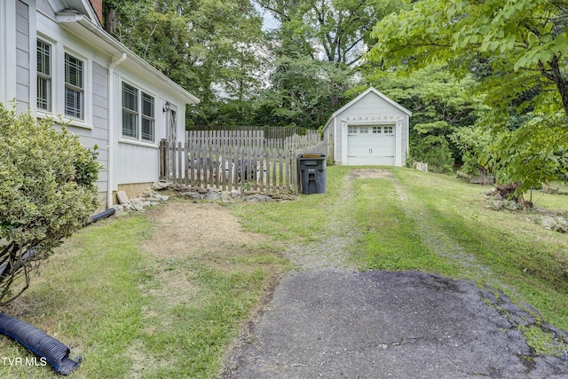 3277 Ashley St, Kingsport, TN 37664 - view of yard with an outbuilding, a garage, driveway, and view of wooded area