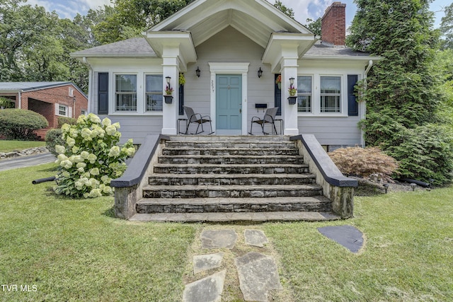 3277 Ashley St, Kingsport, TN 37664 - bungalow-style home featuring a chimney, a front yard, and roof with shingles