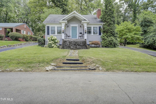 3277 Ashley St, Kingsport, TN 37664 - view of front of house featuring a chimney, a front yard, and view of scattered trees