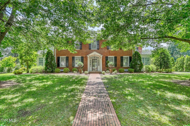 1261 Watauga St, Kingsport, TN 37660 - colonial home featuring a front yard and brick siding