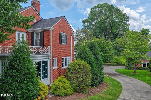 1261 Watauga St, Kingsport, TN 37660 - view of home's exterior featuring brick siding, a balcony, and a chimney
