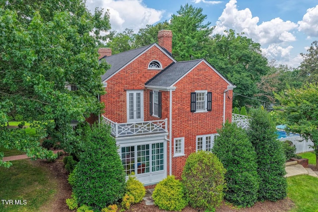 1261 Watauga St, Kingsport, TN 37660 - view of front of property featuring a chimney, brick siding, french doors, and a balcony