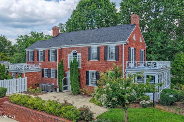 1261 Watauga St, Kingsport, TN 37660 - view of front facade featuring a chimney, a balcony, brick siding, and a shingled roof
