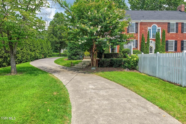 1261 Watauga St, Kingsport, TN 37660 - view of front of property featuring brick siding, concrete driveway, and a chimney