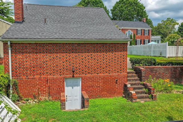 1261 Watauga St, Kingsport, TN 37660 - back of house featuring brick siding, a chimney, and a shingled roof