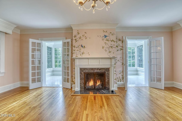 1261 Watauga St, Kingsport, TN 37660 - unfurnished living room featuring wood finished floors, french doors, a fireplace, a chandelier, and crown molding