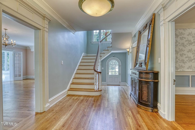 1261 Watauga St, Kingsport, TN 37660 - foyer with light wood finished floors, stairway, a chandelier, ornamental molding, and a wainscoted wall