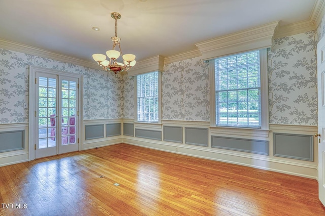 1261 Watauga St, Kingsport, TN 37660 - unfurnished dining area featuring plenty of natural light, a chandelier, wood finished floors, a wainscoted wall, and ornamental molding