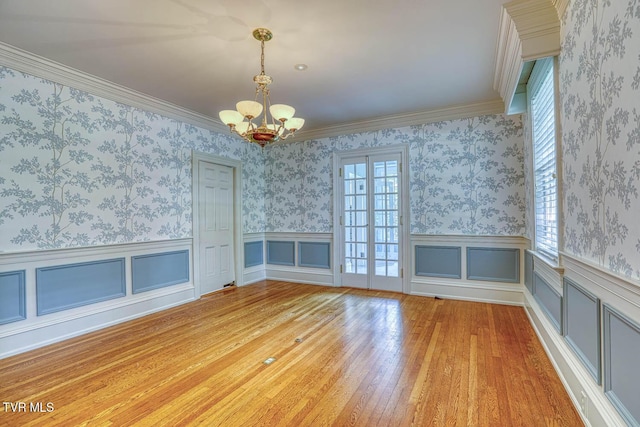 1261 Watauga St, Kingsport, TN 37660 - unfurnished dining area featuring a chandelier, a wainscoted wall, wood finished floors, wallpapered walls, and crown molding
