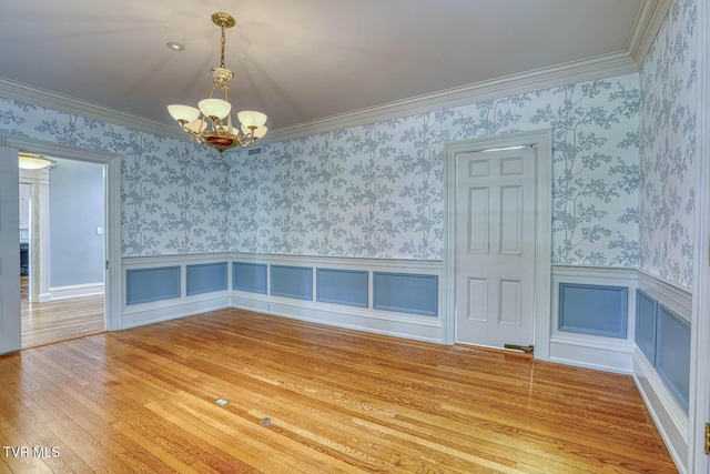 1261 Watauga St, Kingsport, TN 37660 - empty room with a chandelier, wood-type flooring, wainscoting, and wallpapered walls
