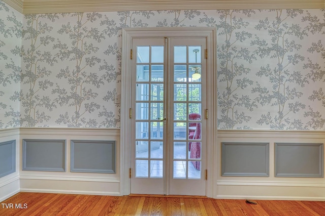 1261 Watauga St, Kingsport, TN 37660 - doorway featuring wallpapered walls, wainscoting, wood finished floors, and plenty of natural light