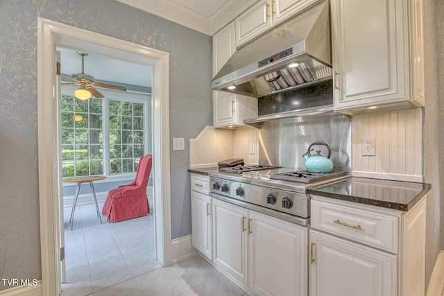 1261 Watauga St, Kingsport, TN 37660 - kitchen with under cabinet range hood, a ceiling fan, white cabinetry, light marble finish flooring, and wallpapered walls