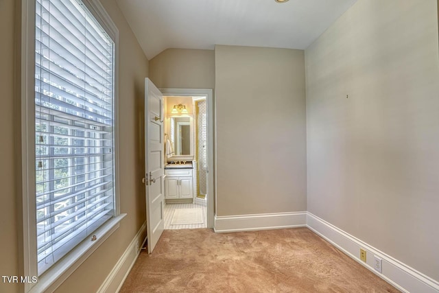 1261 Watauga St, Kingsport, TN 37660 - unfurnished bedroom featuring light carpet, lofted ceiling, and connected bathroom