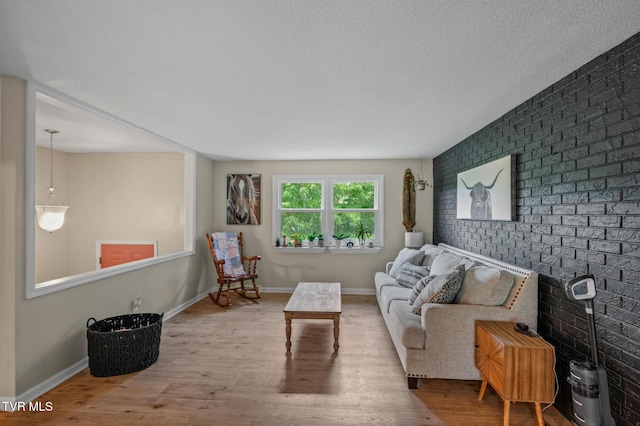 3020 Ridgemont Cir, Kingsport, TN 37663 - living room with wood finished floors, brick wall, and a textured ceiling