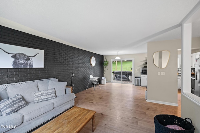 3020 Ridgemont Cir, Kingsport, TN 37663 - living room featuring brick wall and light wood-style flooring