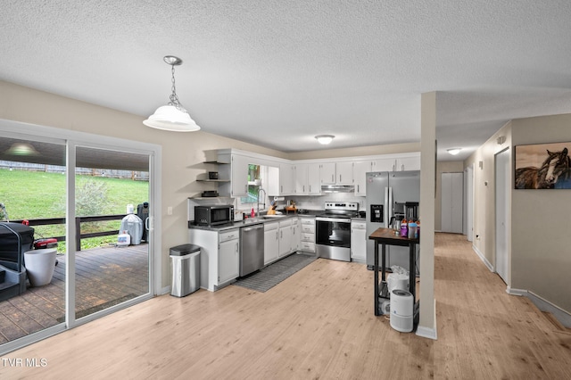 3020 Ridgemont Cir, Kingsport, TN 37663 - kitchen with appliances with stainless steel finishes, open shelves, light wood finished floors, healthy amount of natural light, and a textured ceiling