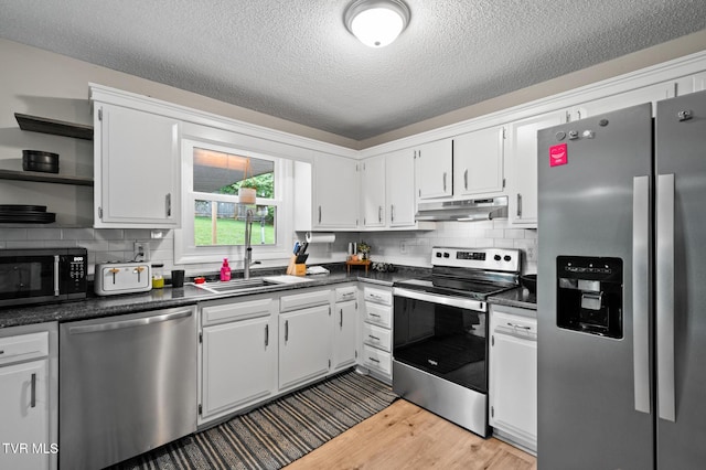 3020 Ridgemont Cir, Kingsport, TN 37663 - kitchen with appliances with stainless steel finishes, under cabinet range hood, open shelves, dark countertops, and a textured ceiling