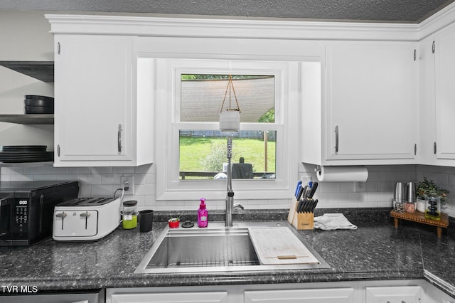 3020 Ridgemont Cir, Kingsport, TN 37663 - kitchen with black microwave, backsplash, and white cabinetry