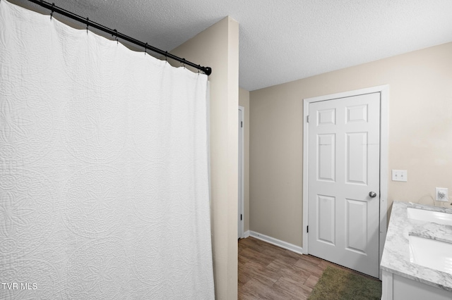 3020 Ridgemont Cir, Kingsport, TN 37663 - full bath featuring a textured ceiling, wood finished floors, and double vanity