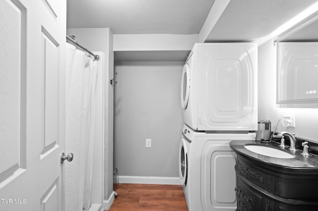 3020 Ridgemont Cir, Kingsport, TN 37663 - washroom with stacked washing machine and dryer, wood finished floors, and a textured ceiling