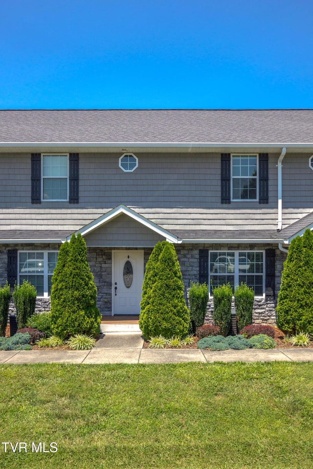 1900 Knob Creek Rd Unit 404, Johnson City, TN 37604 - view of front facade featuring a front lawn, stone siding, and roof with shingles