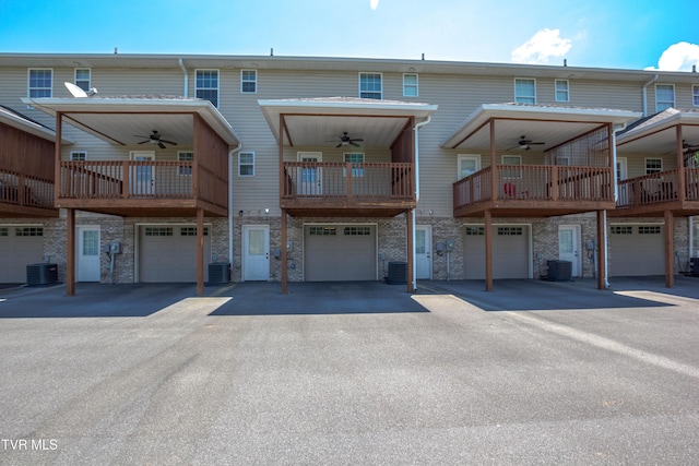 1900 Knob Creek Rd Unit 404, Johnson City, TN 37604 - rear view of house featuring a ceiling fan, a garage, and stone siding
