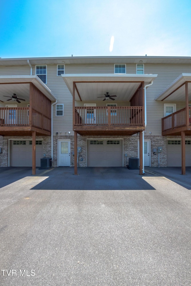 1900 Knob Creek Rd Unit 404, Johnson City, TN 37604 - rear view of house featuring ceiling fan, stone siding, a balcony, and a garage