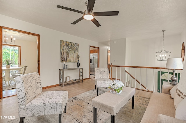 4970 Old Stage Rd, Chuckey, TN 37641 - living area featuring a chandelier, light wood-type flooring, and a ceiling fan