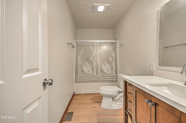 4970 Old Stage Rd, Chuckey, TN 37641 - full bathroom featuring vanity, wood finished floors, a textured ceiling, and enclosed tub / shower combo