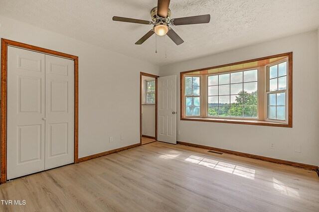 4970 Old Stage Rd, Chuckey, TN 37641 - unfurnished room featuring light wood finished floors, ceiling fan, and a textured ceiling