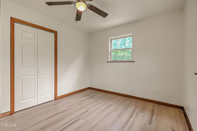 4970 Old Stage Rd, Chuckey, TN 37641 - unfurnished bedroom with light wood-style floors, a closet, and ceiling fan