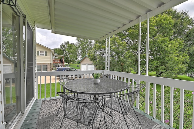 4970 Old Stage Rd, Chuckey, TN 37641 - wooden terrace with outdoor dining space, view of scattered trees, and an outdoor structure