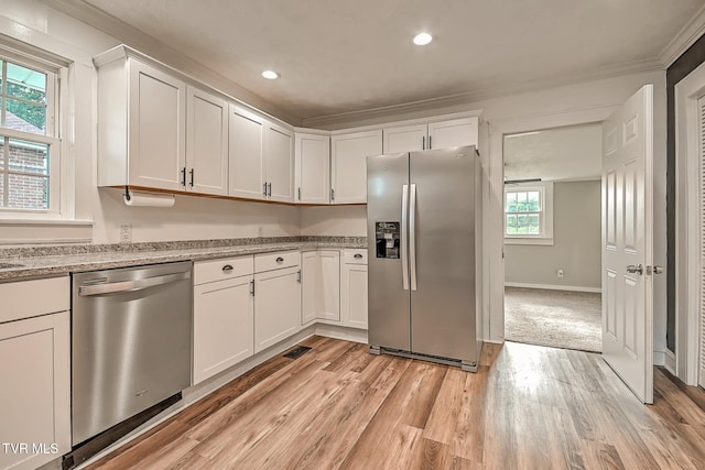 810 N Roan St, Elizabethton, TN 37643 - kitchen with appliances with stainless steel finishes, ornamental molding, white cabinets, recessed lighting, and light wood-style flooring