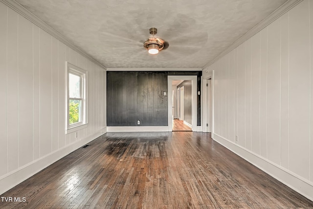 810 N Roan St, Elizabethton, TN 37643 - empty room featuring ornamental molding, hardwood / wood-style floors, and wooden walls