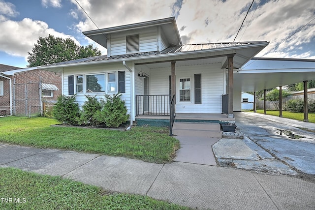 810 N Roan St, Elizabethton, TN 37643 - view of front of home with a porch, driveway, a metal roof, a carport, and a standing seam roof