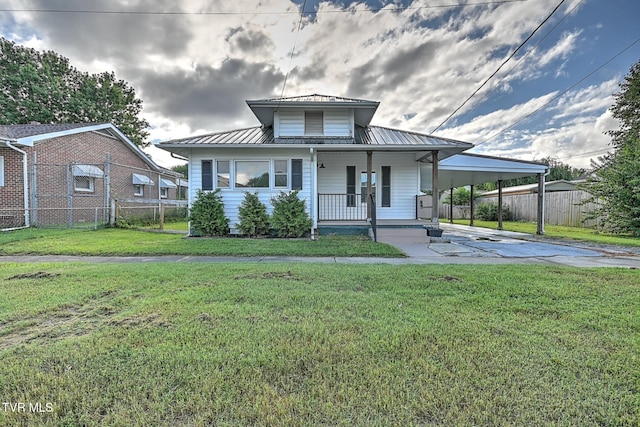 810 N Roan St, Elizabethton, TN 37643 - view of front of property featuring a porch, a carport, concrete driveway, a standing seam roof, and a metal roof