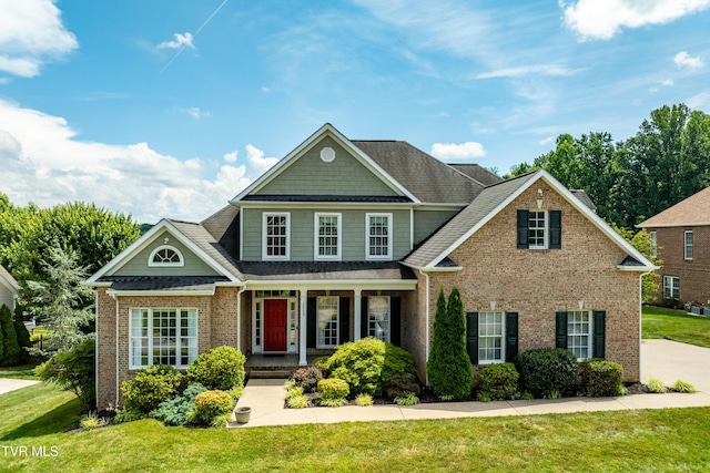 2003 Hackberry Dr, Jonesborough, TN 37659 - view of front of home with brick siding, covered porch, a front yard, and roof with shingles