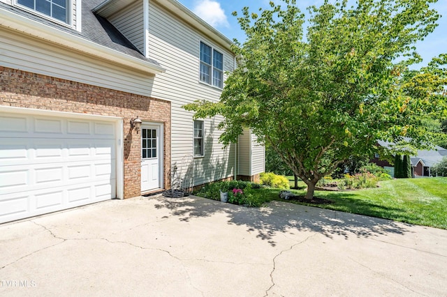 2003 Hackberry Dr, Jonesborough, TN 37659 - view of home's exterior with concrete driveway, brick siding, a lawn, and roof with shingles