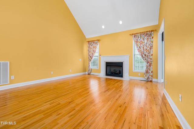 2003 Hackberry Dr, Jonesborough, TN 37659 - unfurnished living room with high vaulted ceiling, a fireplace with flush hearth, light wood-style flooring, and recessed lighting